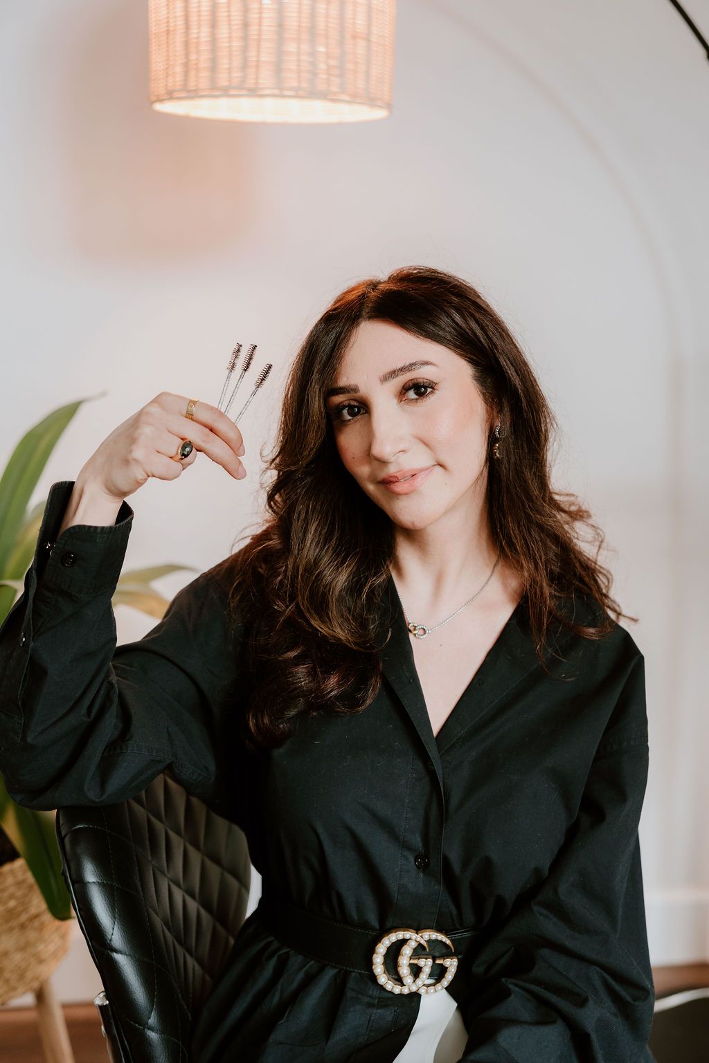 Lash artist holding up a handful of lash wands