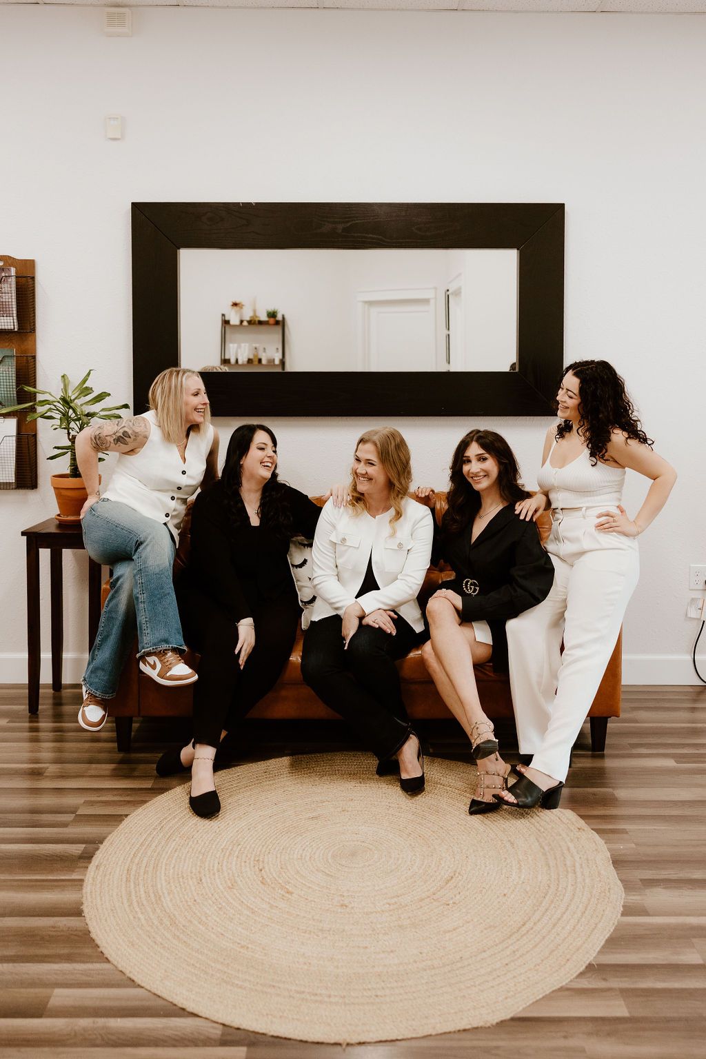 The Lash Candy team sitting together on the lounge sofa
